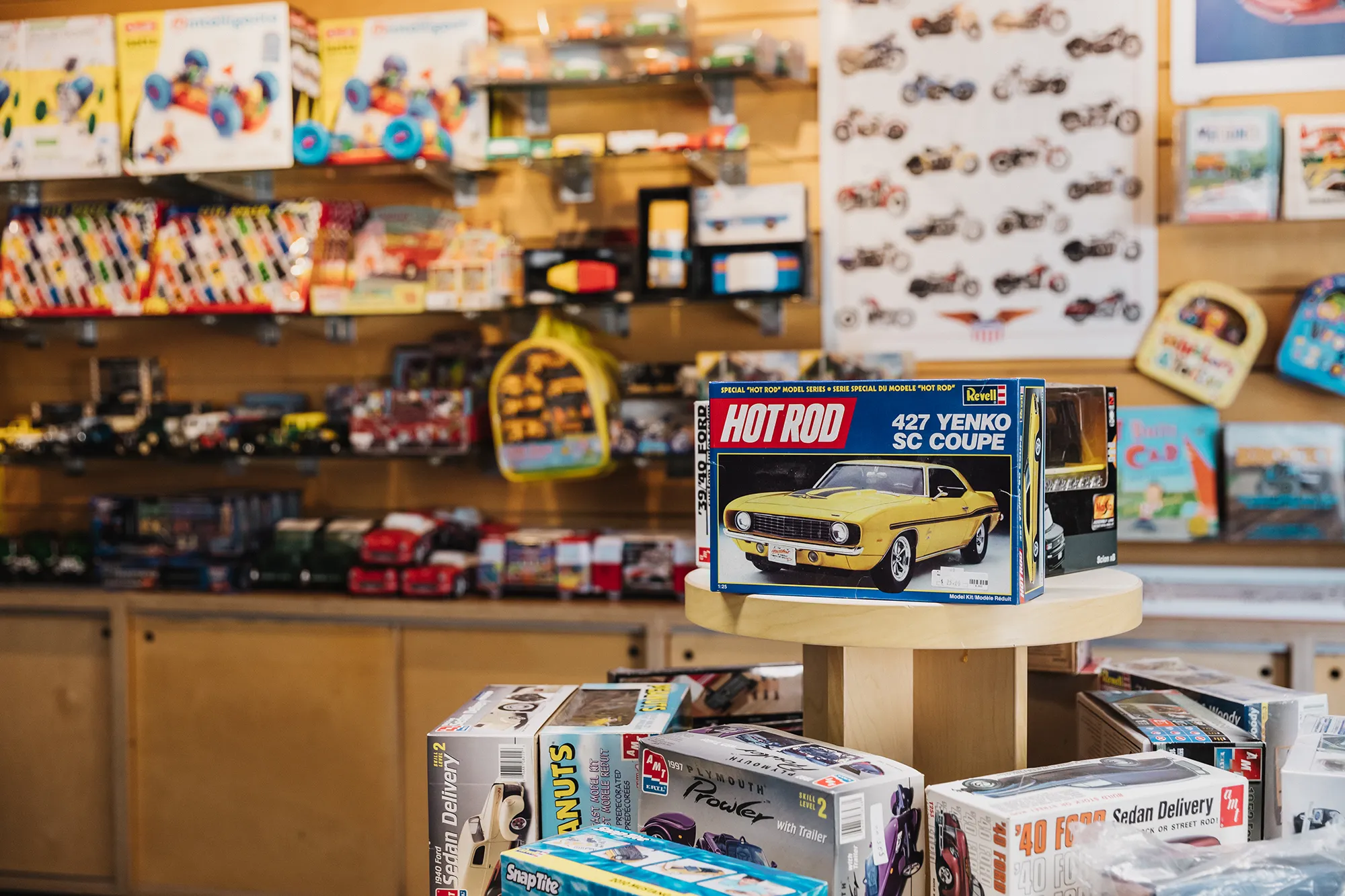 Displays of various model cars inside the San Diego Automotive Museum gift shop.
