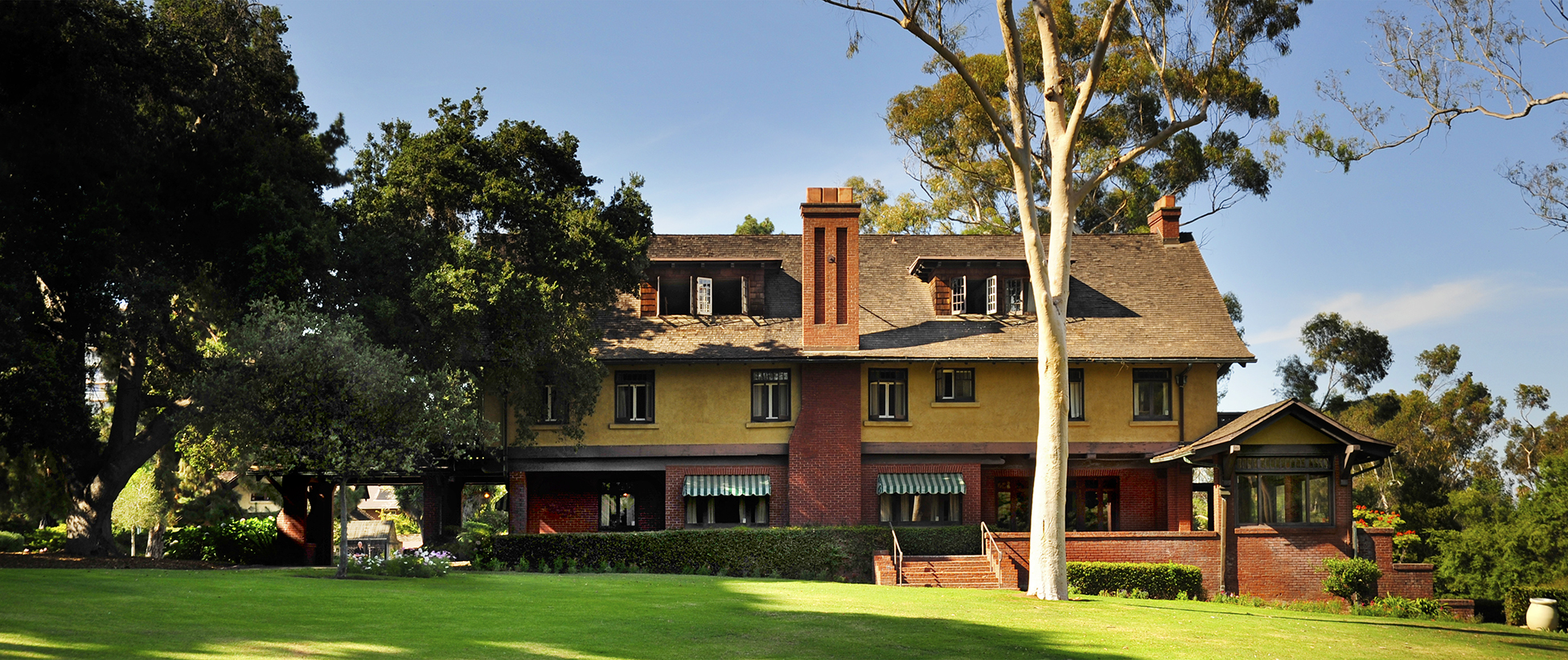 The Marston House building from the outside. The building is red and yellow with a brown roof.