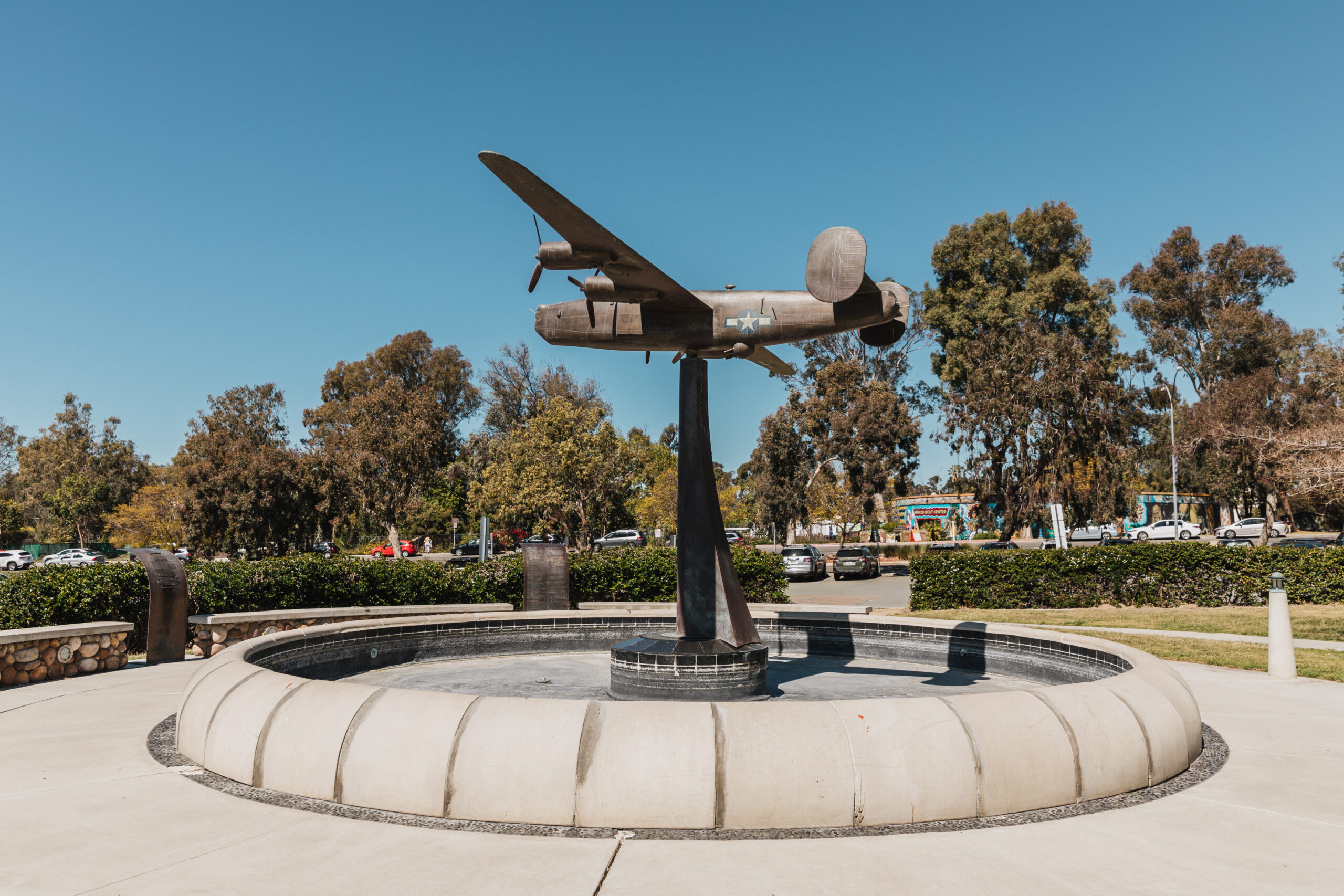 A bronze statue of a WWII B-24 Liberator, a one-sixth scale replica with an 18′ wingspan, is the centerpiece of the Veterans Memorial Garden, soaring over a reflecting pool.