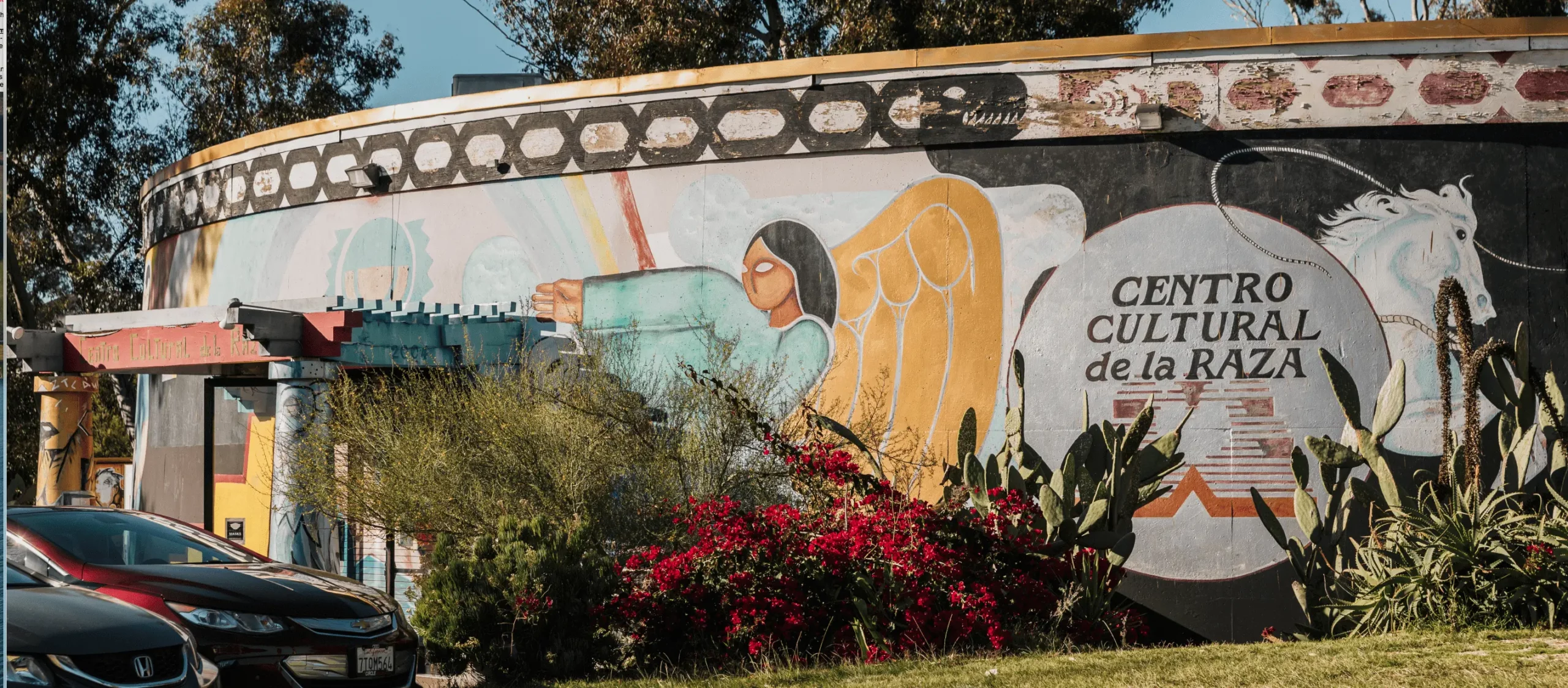 Centro Cultural del la Raza building with colorful murals depicting people and animals.