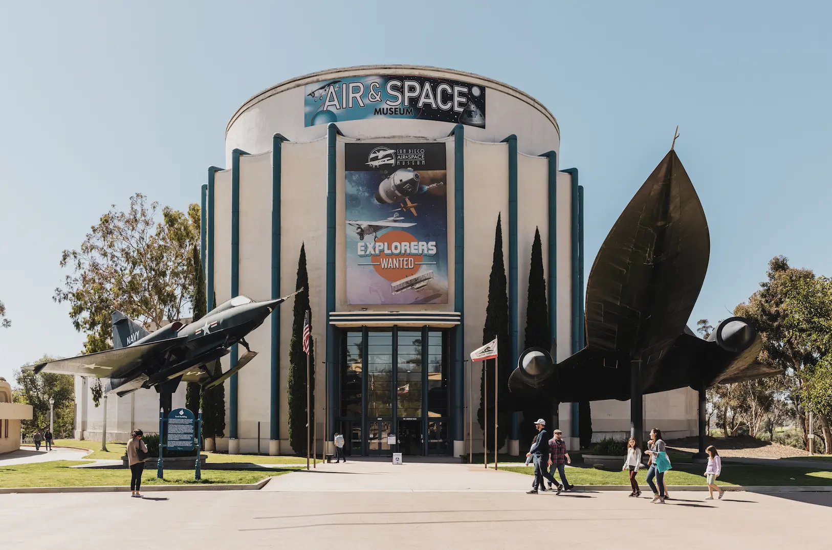 Visitors walking into the entrance of the San Diego Air and Space Museum.