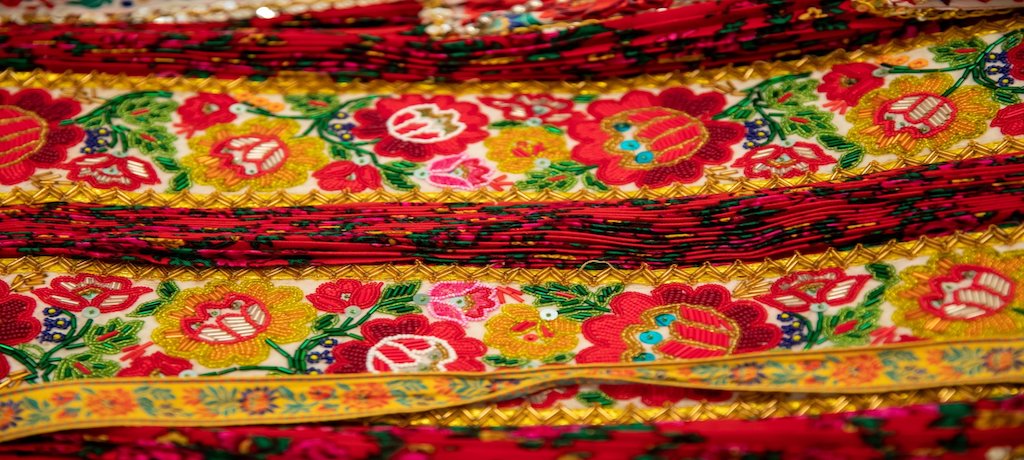 yellow and red beaded fabric with flowers