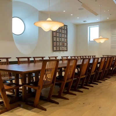long wooden table with chairs surrounding it