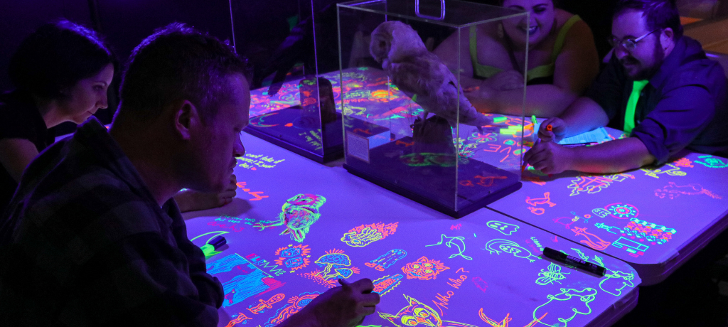 People drawing in neon lights