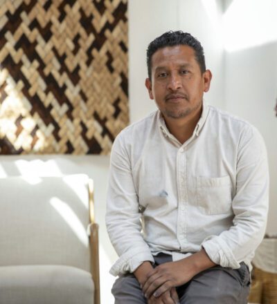 man in a white shirt sitting on a chair