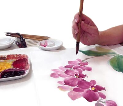 Person painting pink Chinese Flowers