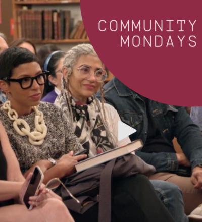 Community Mondays. Two women in glasses are sitting down and looking forward.