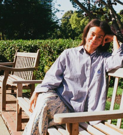 Woman in a blue shirt sitting on a bench