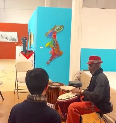 person sitting and playing the drums