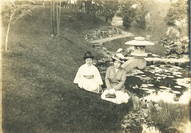 Yone Shima (right) and another woman sitting by a pond in a newly constructed Japanese garden on the Sefton Estate in Point Loma, April 1919.
