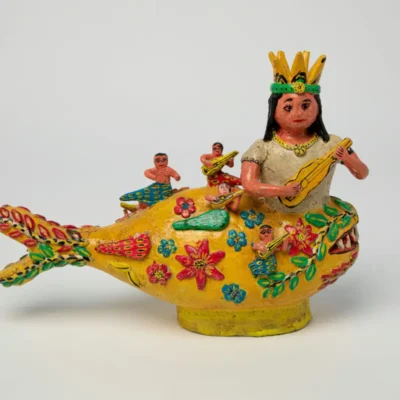 fish vase with a woman with a crown sticking out of it